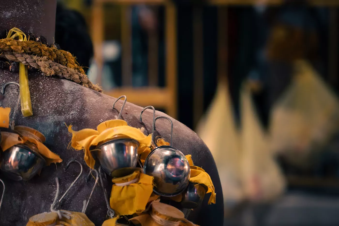 A devotee at Thaipusam in Kuala Lumpur's Batu Caves, wearing small silver milk pots on their body using hooks through their skin.