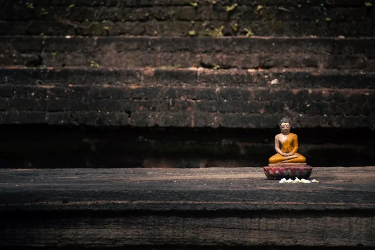 A small seated Budha figurine with offerings found at the ancient city of Polonnaruwa, Sri Lanka.