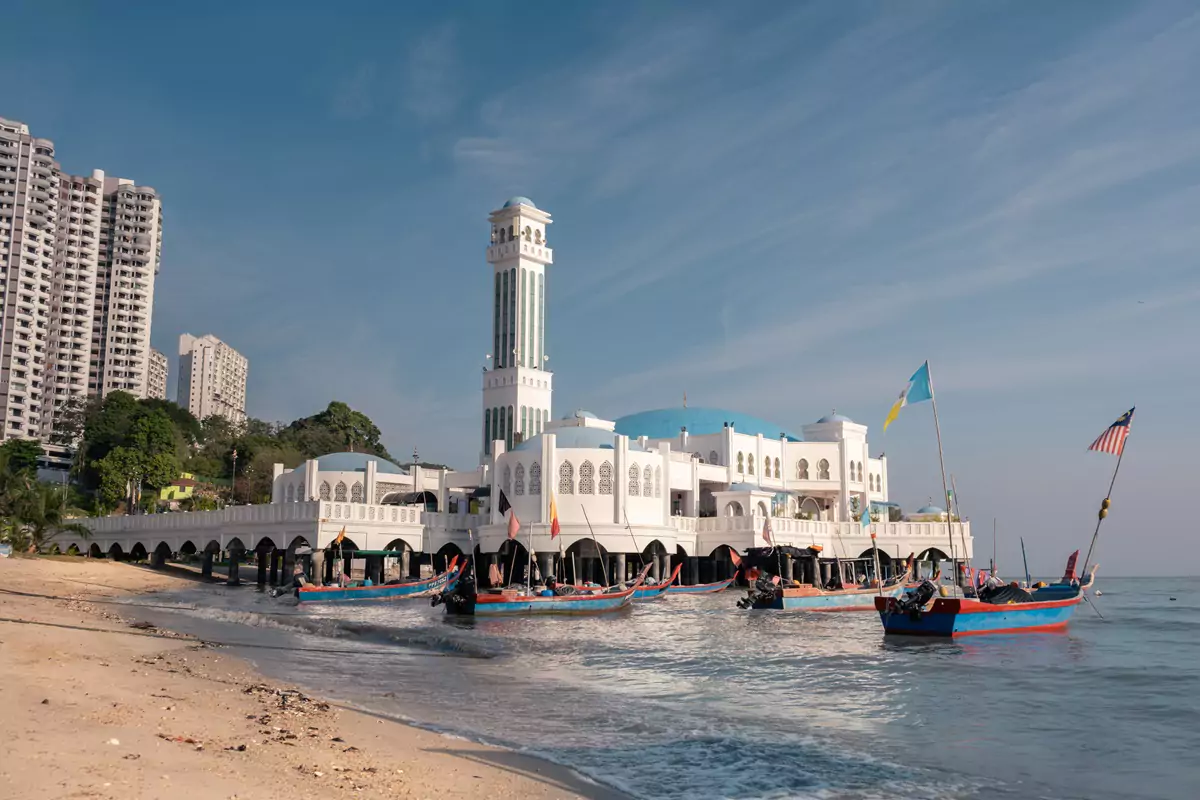 Colourful painted boats by the beach next to the Floating Mosque in Penang, Malaysia.