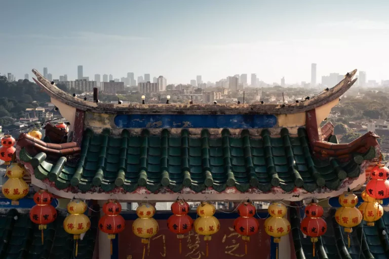 Views over the a tiled roof of George Town from the third level of Kek Lok Si in Penang, Malaysia.