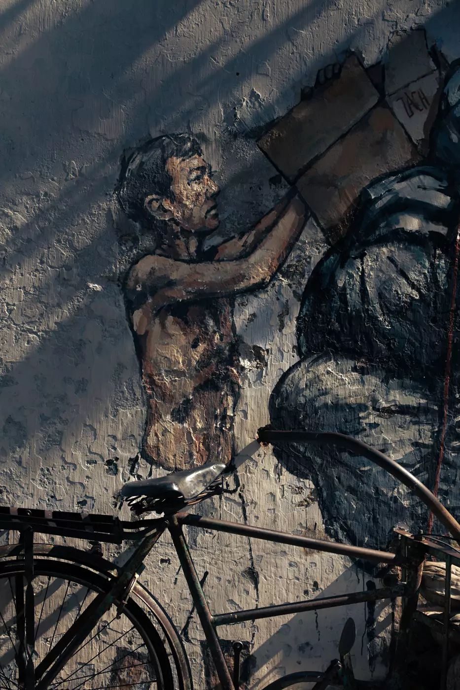 A 3-D art installation in Market Lane making use of a real bicycle. The mural by Ernest Zacharevic shows a person collecting bags of rubbish.
