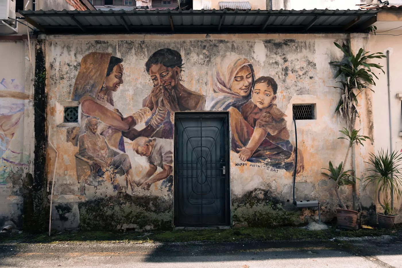 A fresco in Mural Art's Lane in Ipoh celebrating mothers day. The mural depicts a number of acts of kindness/love between mothers and daughters.