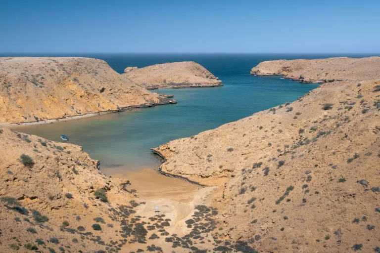 A lone vessel on the waters near a beach at Bandar Khairan near Muscat, Oman.