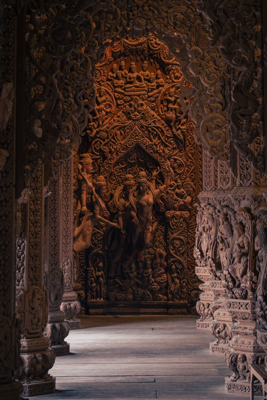Intricate wooden carvings and pillars inside a wing of the main building at Sanctuary of Truth.
