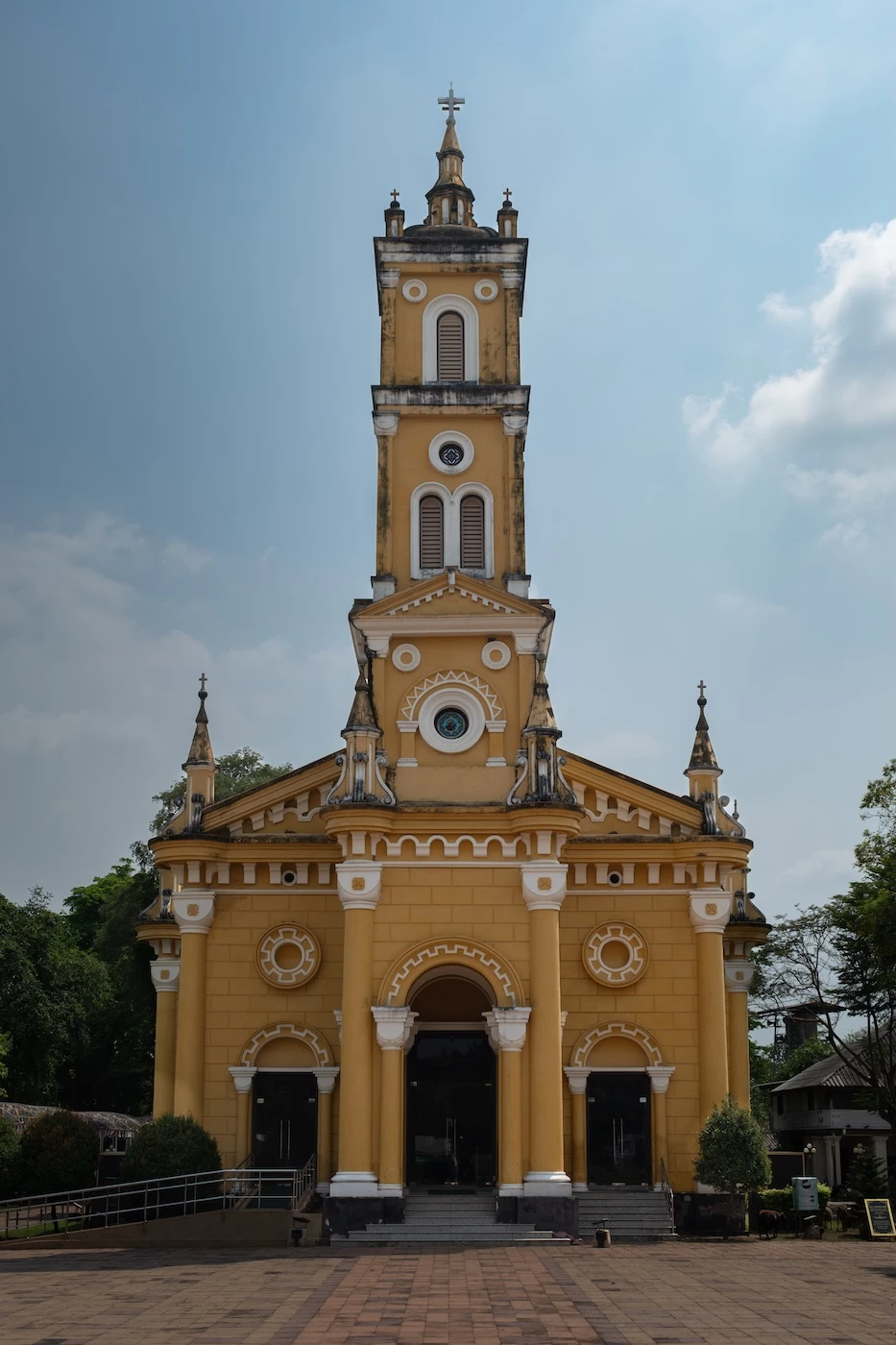 Yellow and white exterior of the Romanesque St. Joseph's Church near Ayutthaya.