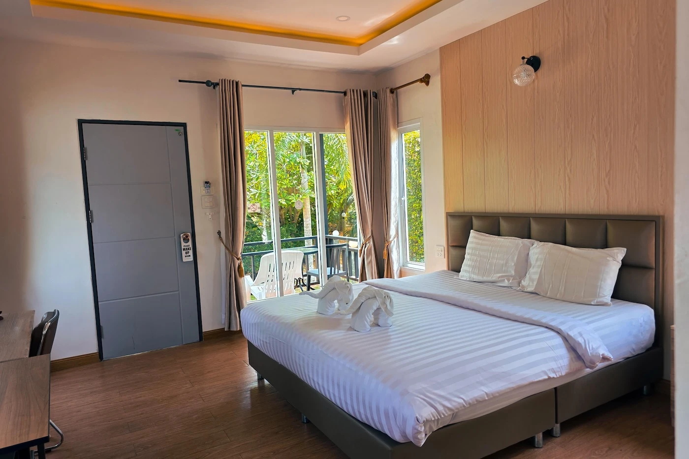 Towels shaped into elephants, sat upon a bed at the Koh Yao Modern Inn.