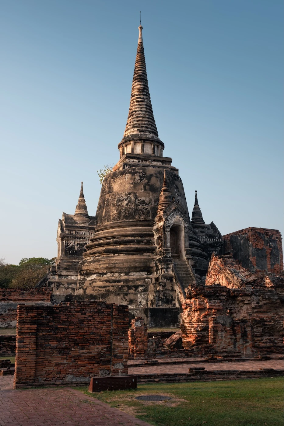 An ancient white stone chedi in the evening light at Wat Phra Si Sanphet, Ayutthaya.