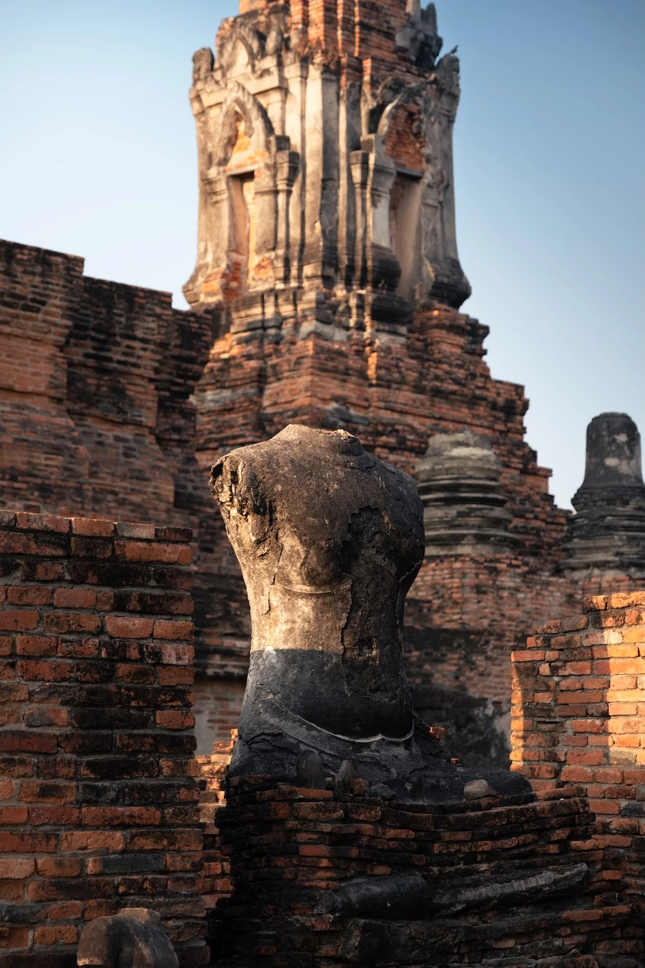 A statue missing its arms and head at Wat Phra Ram temple ruins.