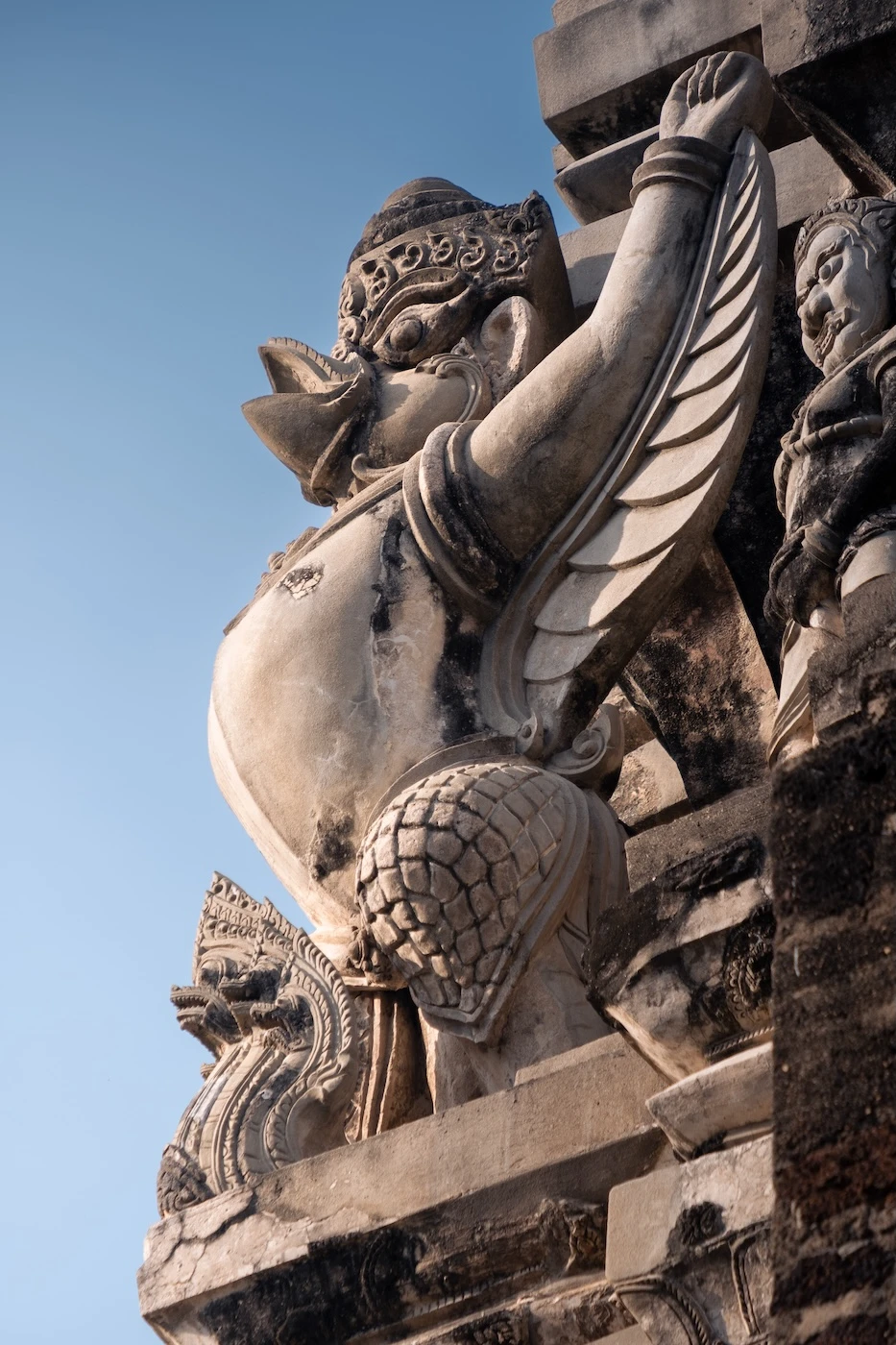 A garuda statue on the external walls of a prang tower at Wat Ratchaburana.
