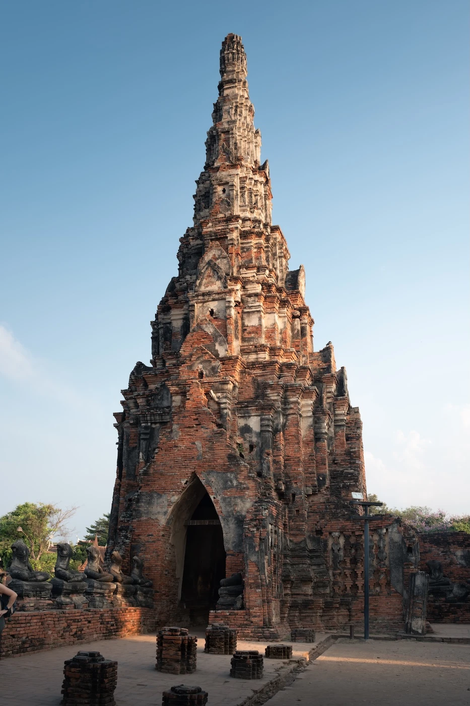 A khmer style brick built prang with an entryway, within the temple ruins of Wat Chaiwatthanaram.
