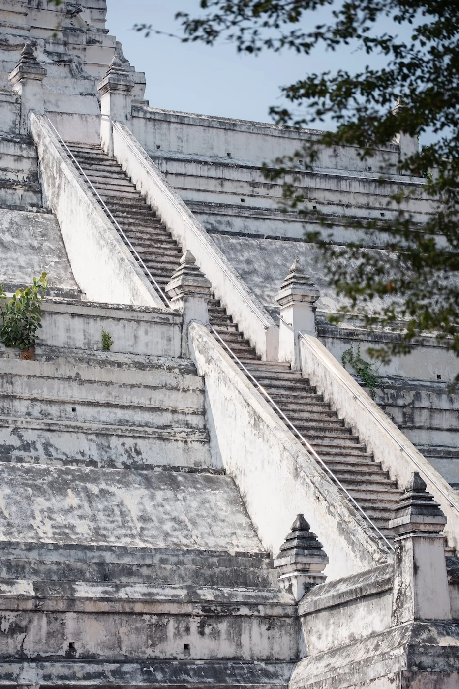 Large white coloured stairs leading up Wat Phu Khao Thong temple.