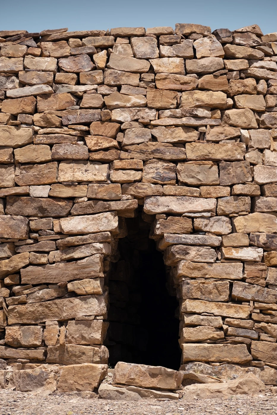 A small entrance built into the brick built Bat Tombs in Oman.