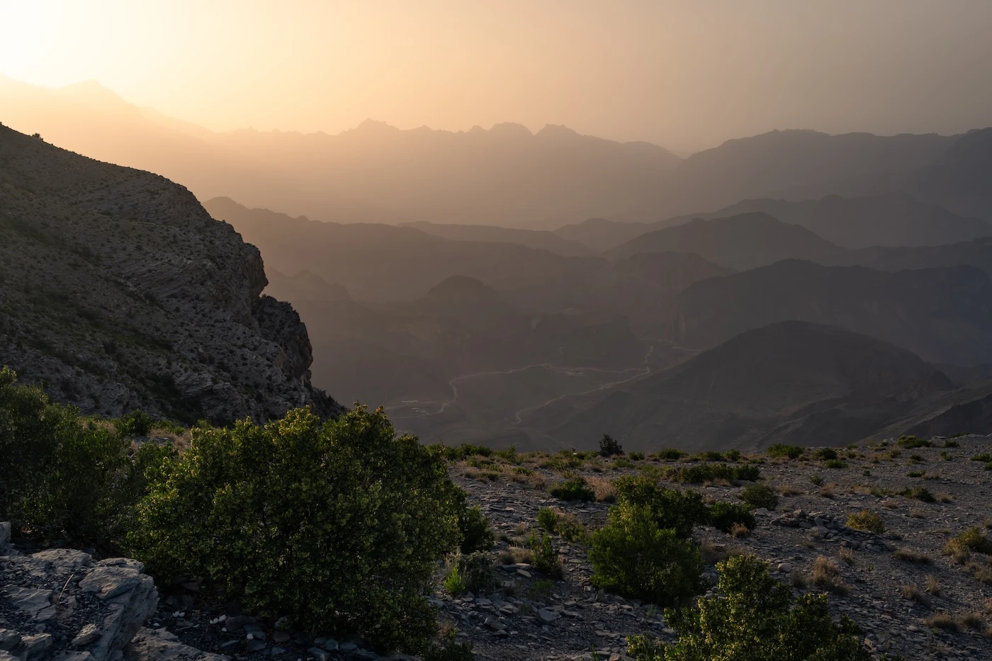 Hazy views during Omani summer atop Jebel hatt across Wadi Awf below.