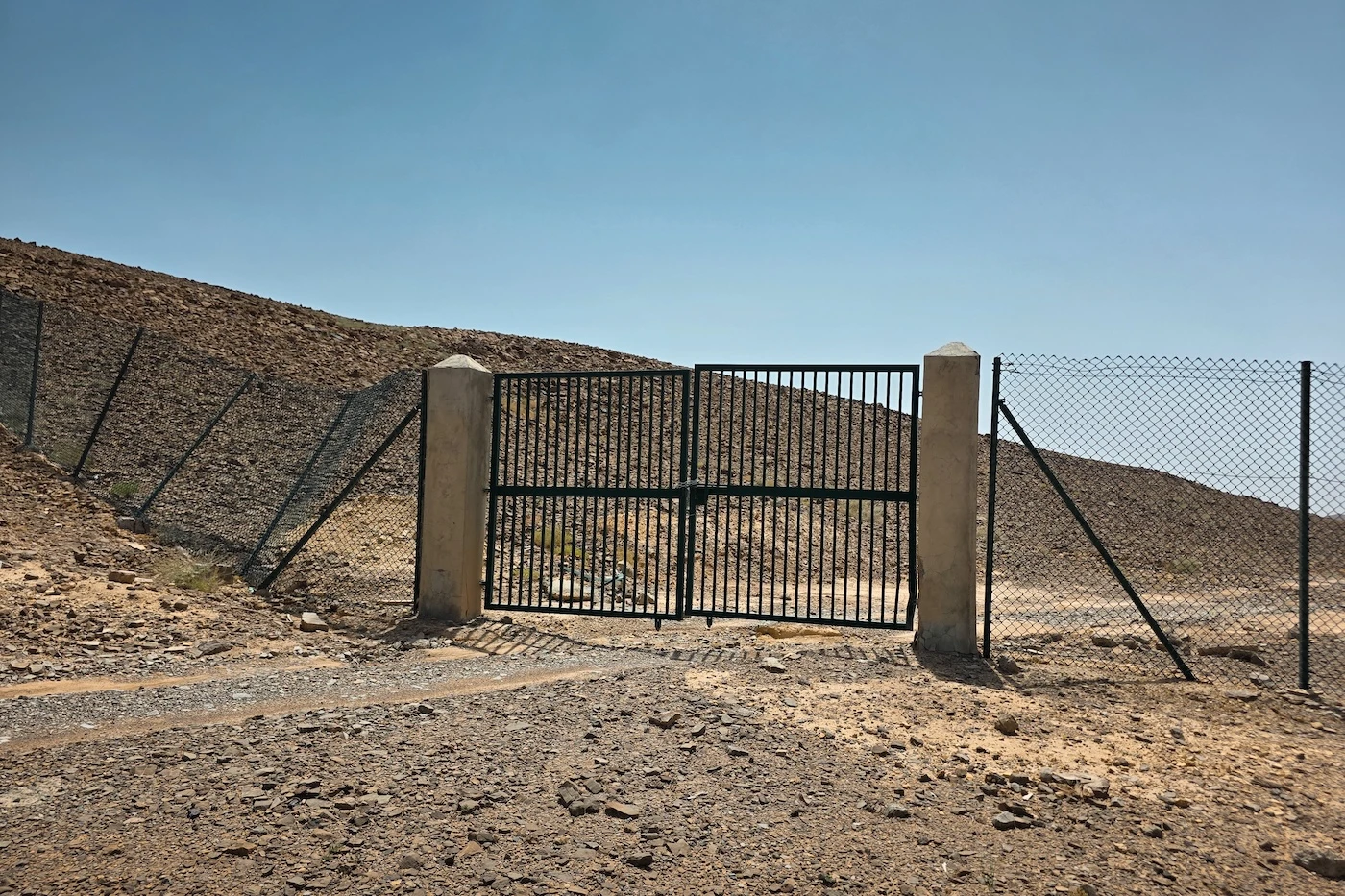 A locked gate outside the Bat archaeological site in the Hajar Mountains.