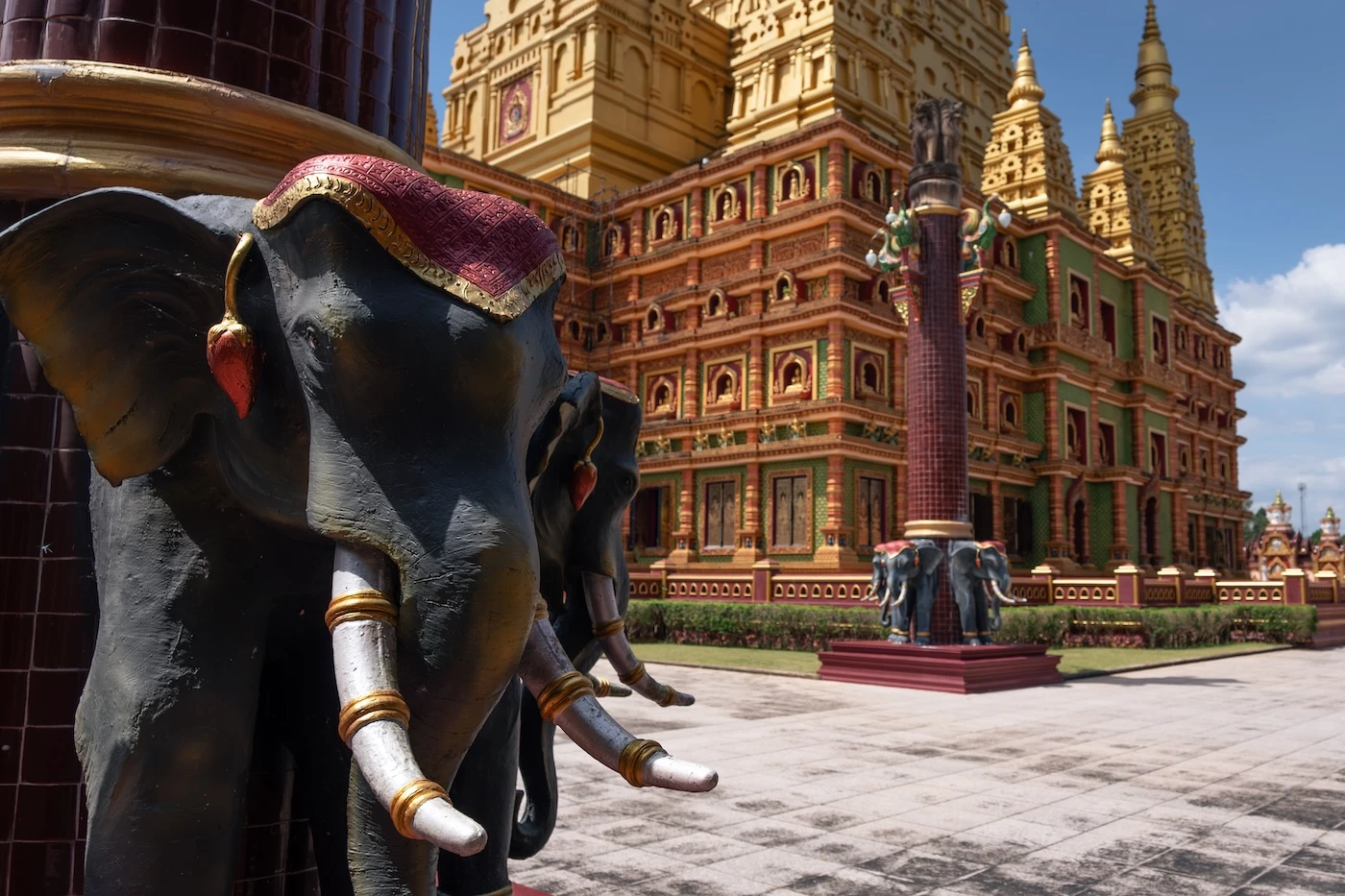Elephant head at the base of a column in the manicured gardens at Wat Bang Tong temple complex in Krabi.