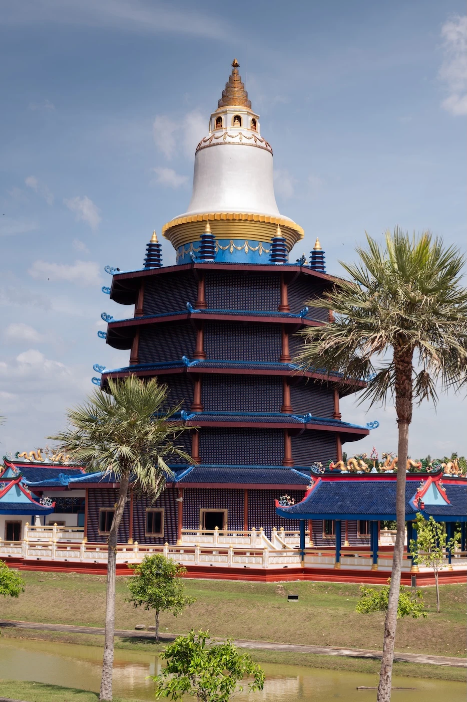 A blue pagoda with a white and gold-tipped chedi atop, dedicated to Guanyin at Wat Bang Thong Temple.