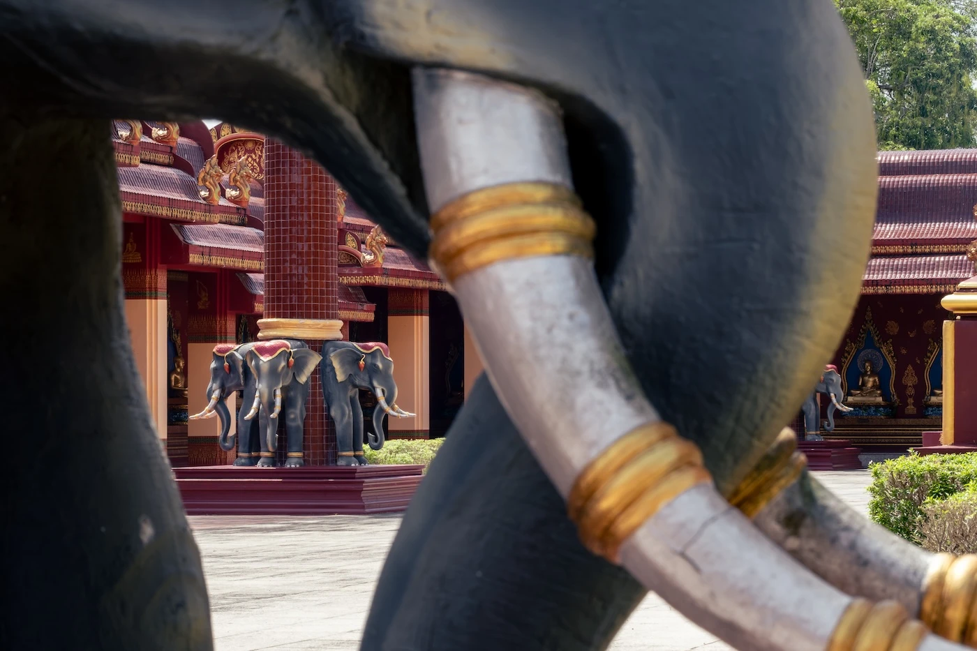 Elephant statues at the base of a column in the temple complex of Wat Bang Thong.