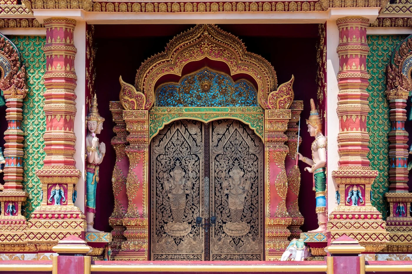 A Ganesh engraved wooden door at the entrance to a temple building at Wat Bang Thong.