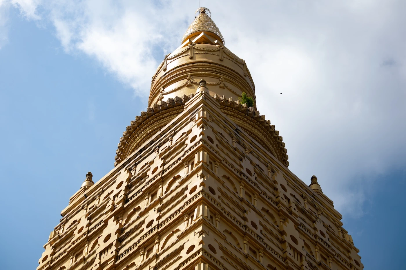 Golden exterior walls of Wat Bang Thong in the sunlight.