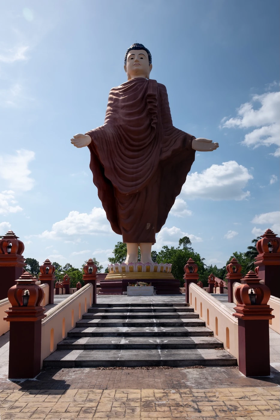 A giant statue of Buddha in a standing Pang Poet Lok posture at Wat Bang Thong Temple in Krabi, Thailand