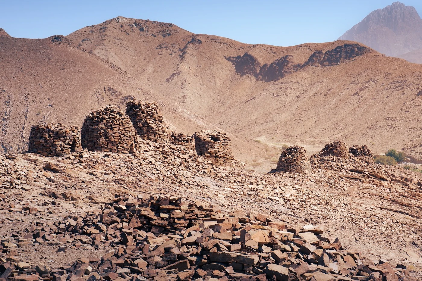 Beehive tomb ruins in the sparse countryside at Al Ayn near Nizwa, Oman.